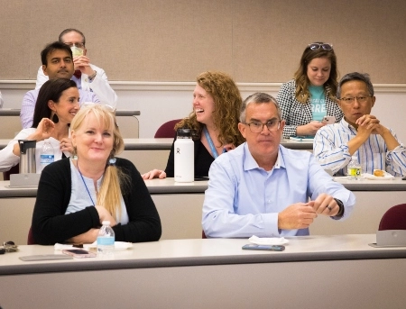 School of Medicine faculty sitting in a lecture hall during the faculty awards ceremony.