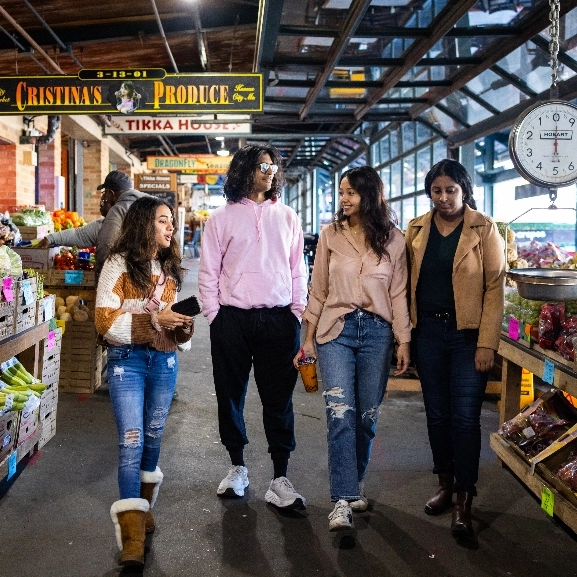 Four students walking in Kansas City River Market.