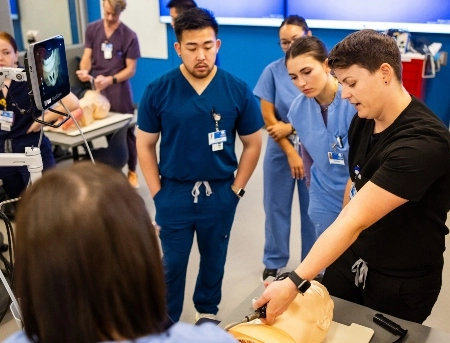 A faculty member provides instruction during an airway lecture.