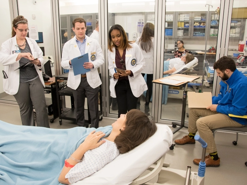 UMKC School of Medicine and School of Pharmacy students practice consulting with a patient through the Standardized Patient program.