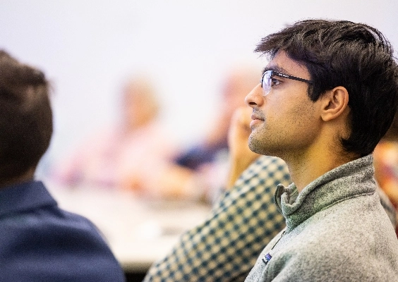 A medical student listening intently to a class lecture.