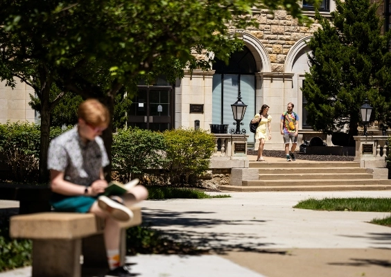 Students walking around outside on UMKC's campus.