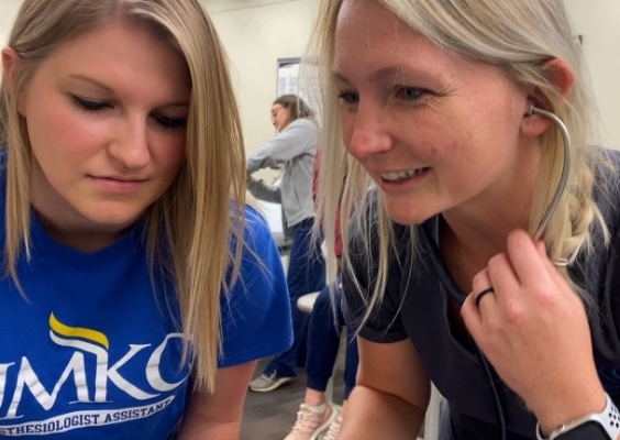 Two medical students working together in class.