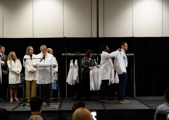 A PA student receives his white coat during the PA White Coat Ceremony.