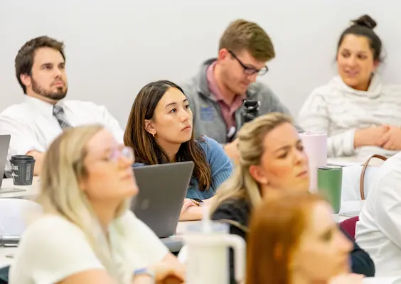 Surgery students listening to a class lecture.