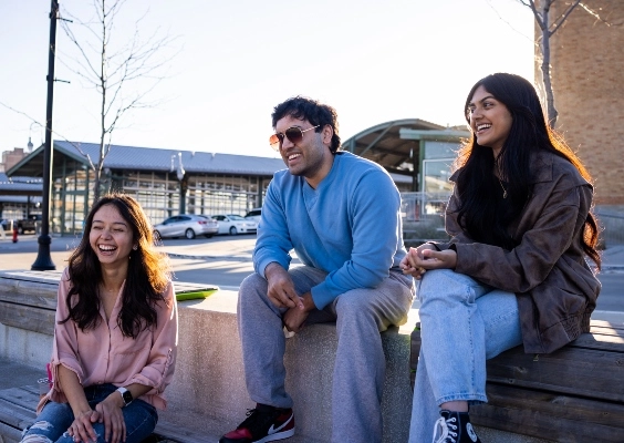 UMKC students laughing together as they hang out in Kansas City's River Market.