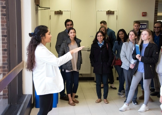 Prospective students listening to a current med school student as she gives a tour at the UMKC School of Medicine.