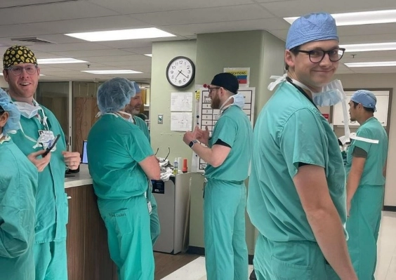 Anesthesiology residents smiling and hanging out in the hospital between patients. 