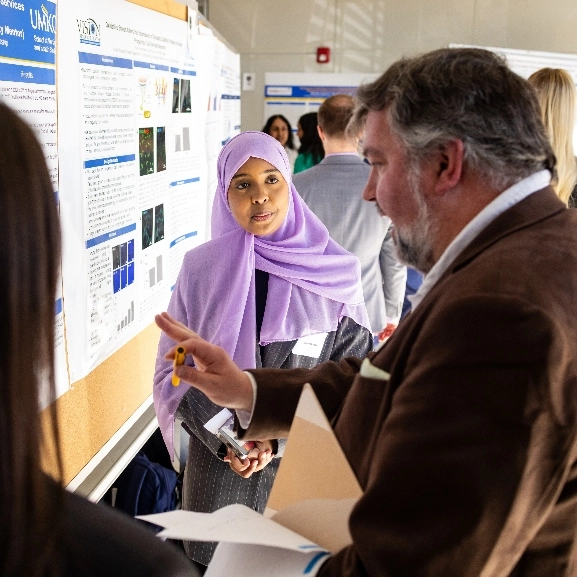 a student explains a presentation to a colleague