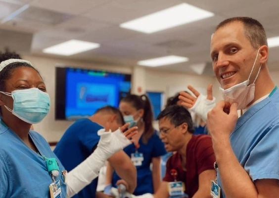 Family medicine residents showing off their casts after a workshop.