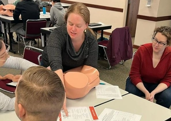 Family medicine resident working with other residents during a training workshop.