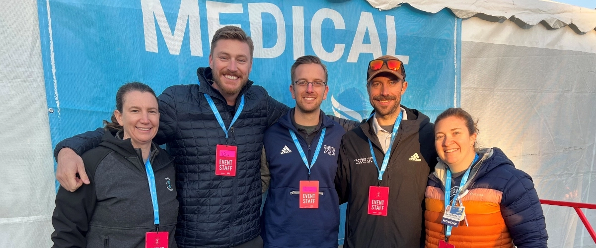 Sports medicine faculty pose for a photo at an event.