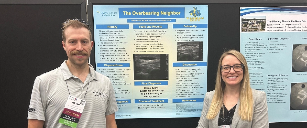 Two sports medicine fellows stand in front of their research presentation poster.