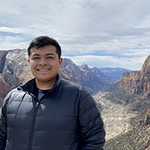 Fernando outside with mountains and valley behind him