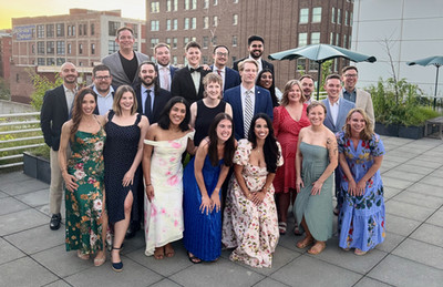 Emergency Medicine residents pose for a group photo after graduation on a roof top in Kansas City.