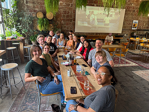group of people having coffee and visiting at a dining table