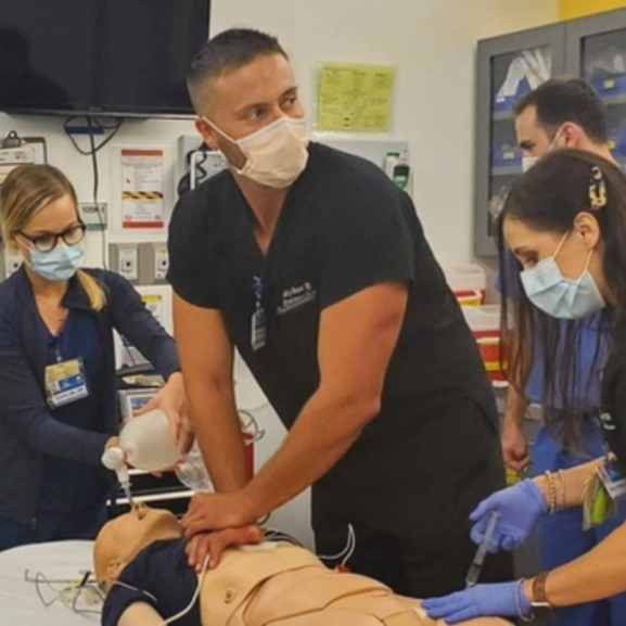 Emergency medicine faculty demonstrate a procedure during simulation training.