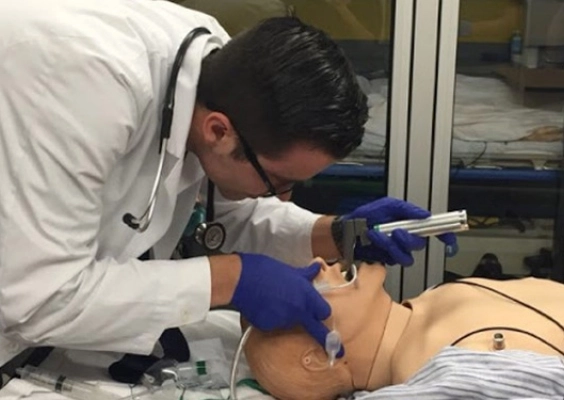 A medical student practices intubation during simulation training. 