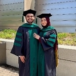 Portrait of Adnan Islam and his wife in their graduation caps and gowns.