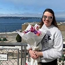 Portrait of Kara Alright holding a bouquet. 