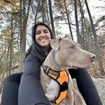 Portrait of Pooja Patel with her dog.