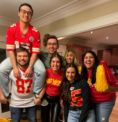 group photo with people wearing Chiefs jerseys