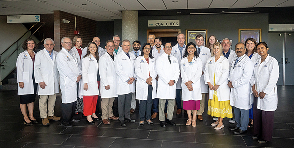 docent group photo wearing whie coats