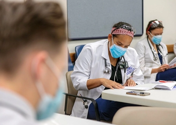 An internal medicine resident studies at a hospital desk.