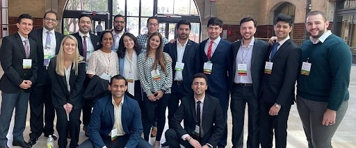 IM residents dressed in professional attire posing for a group photo.