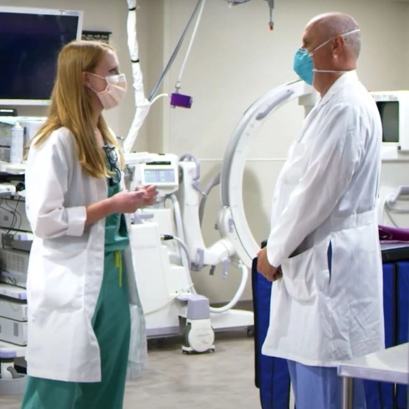 A fellow talking with a faculty member about patient care.