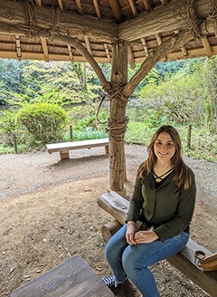 Brandi Jungels sitting on a trail bench.