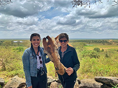 Megan Carroll petting a giraffe.