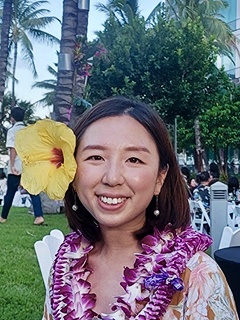 Eun Young Park in Hawaii wearing a lei and a flower in her hair.