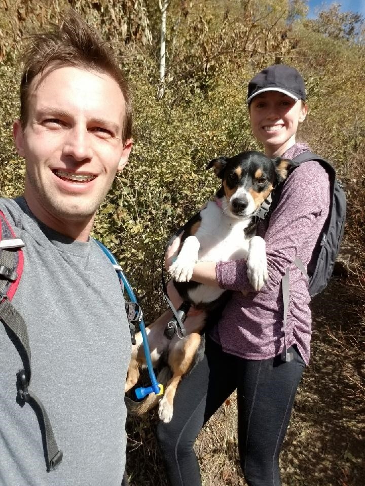 Lauren Fay with his partner and dog on a hike.