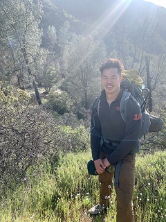 Jonathan Liau smiling posing for a photo during a hike.