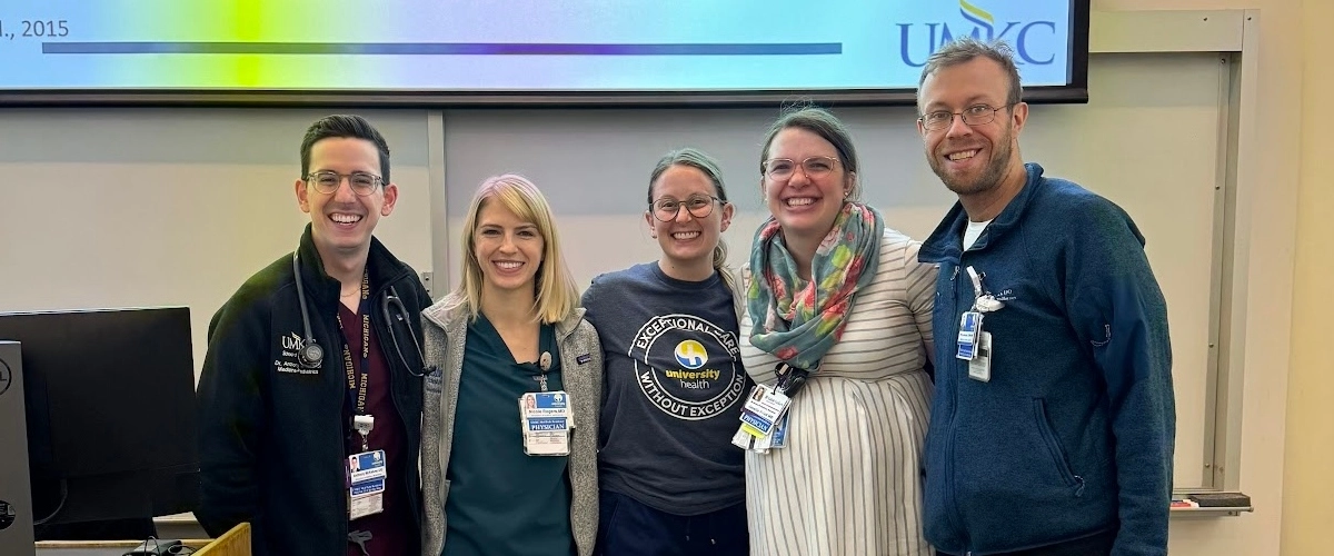 Full MedPeds residency group posing for a casual photo outside.