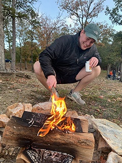 Hank Unterschuetz lighting a campfire.