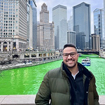 Abdelsabour in front green Chicago river and city skyline