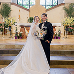 bride and groom in front of an altar