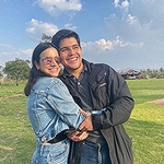 sunny day with man and woman hugging in grassy field