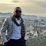 Mohammad above cityscape behind him at sunset