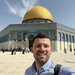 Muath standing in frfont of a building with a gold dome