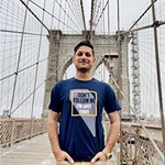 Abdul standing on a bridge with it's cables and beams behind him