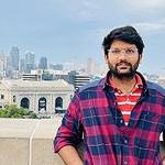 Jagadish with the Kansas City skyline behind him