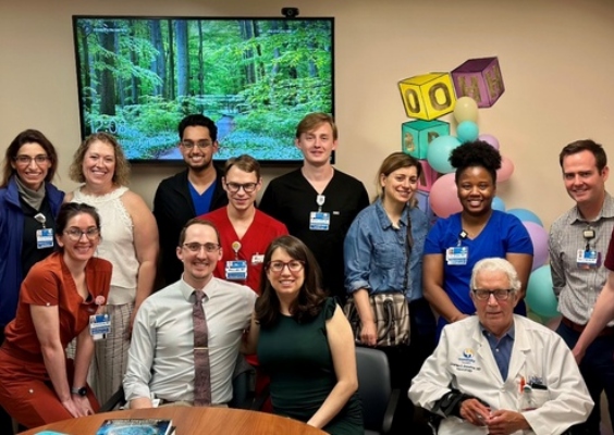 group of students in a conference room smiling at camera