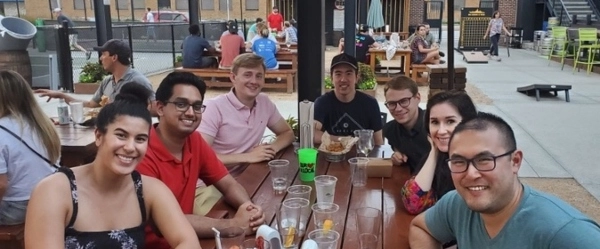 Residents smiling at a team lunch outside.