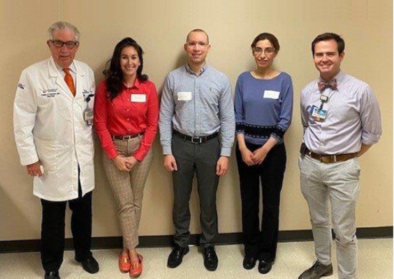 Neurology residents stand with faculty for a group photo.