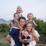 Portrait of Jared Bodine, OBGYN resident, with his wife and children.