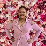 Portrait of Carnita Cannon, OBGYN resident, in front of rose background