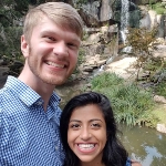 Portrait of Arhita Dasgupta, OBYGN resident, with her partner in front of a waterfall.